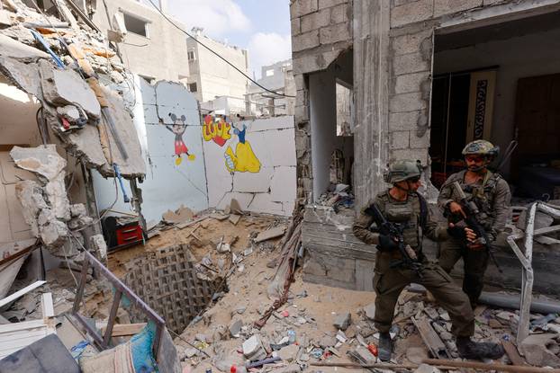 FILE PHOTO: Israeli soldiers stand guard at the entry to the tunnel where the bodies of six Israeli hostages killed by Hamas were recovered by Israeli forces earlier this month, in Rafah