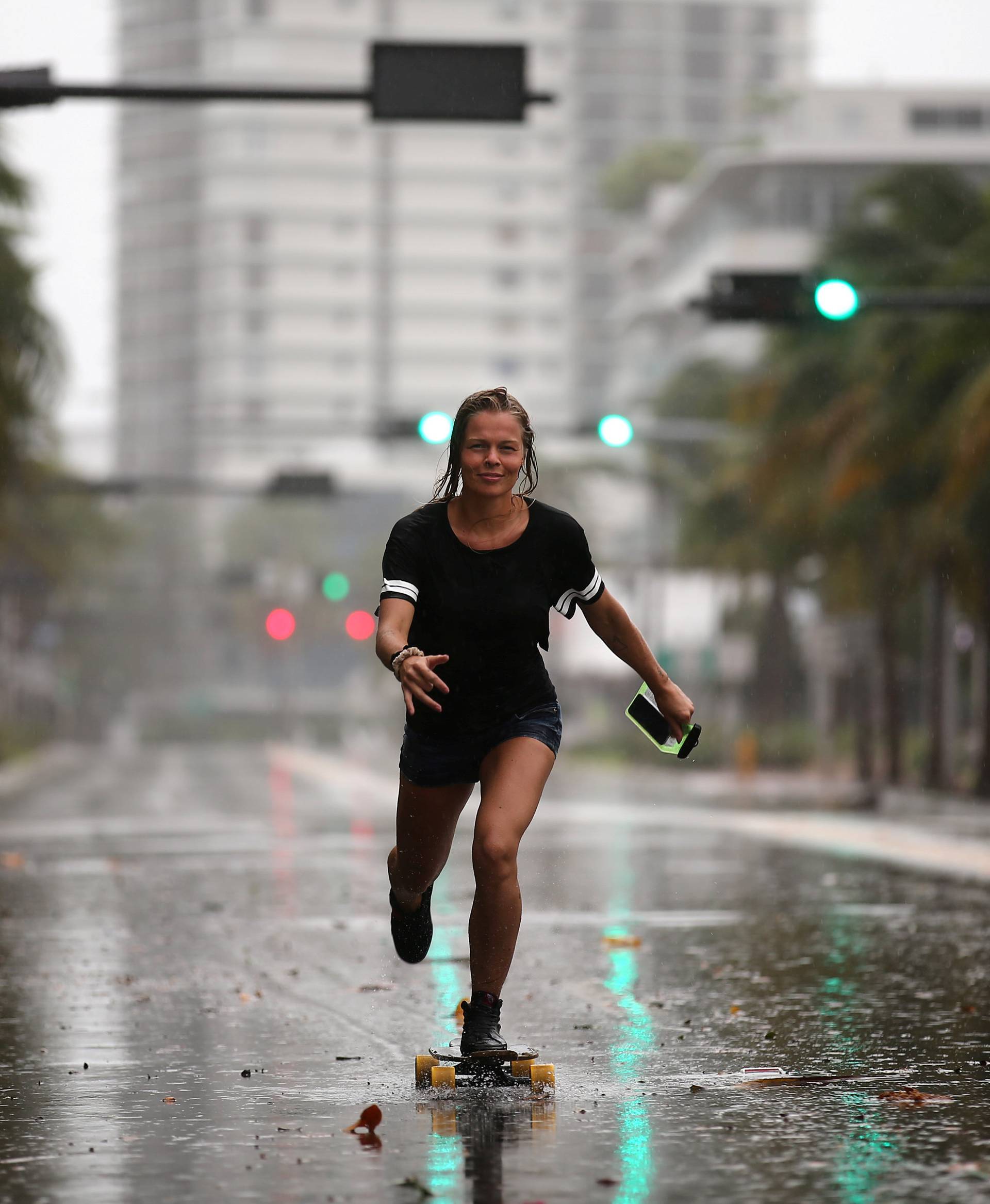 A local resident rides a skateboard before the arrival of Hurricane Irma to south Florida