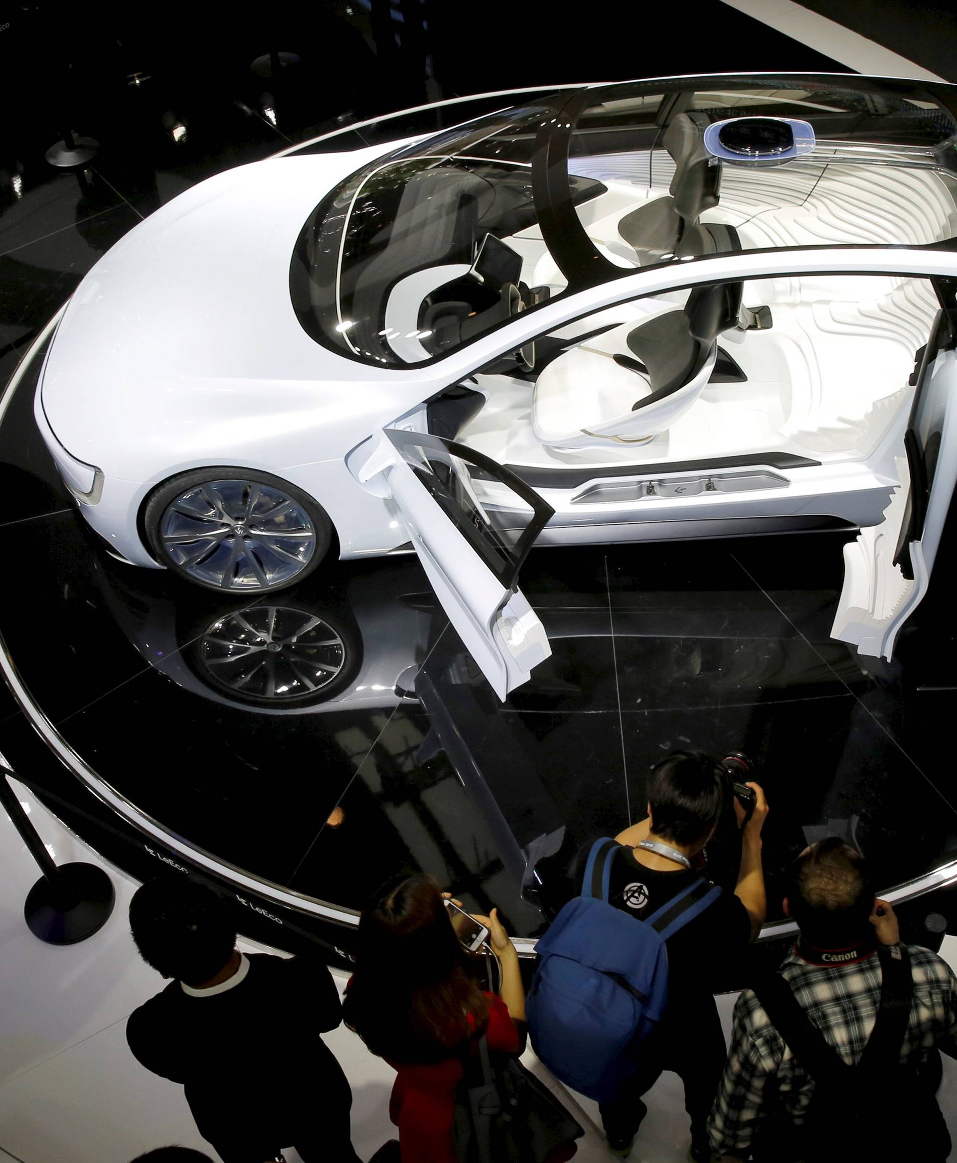 Visitors look at all-electric battery concept car called LeSEE during Auto China 2016 auto show in Beijing