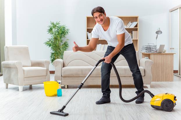 Man husband cleaning the house helping wife