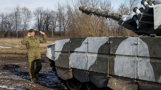 A Ukrainian serviceman directs a tank for repairs in northern Ukraine