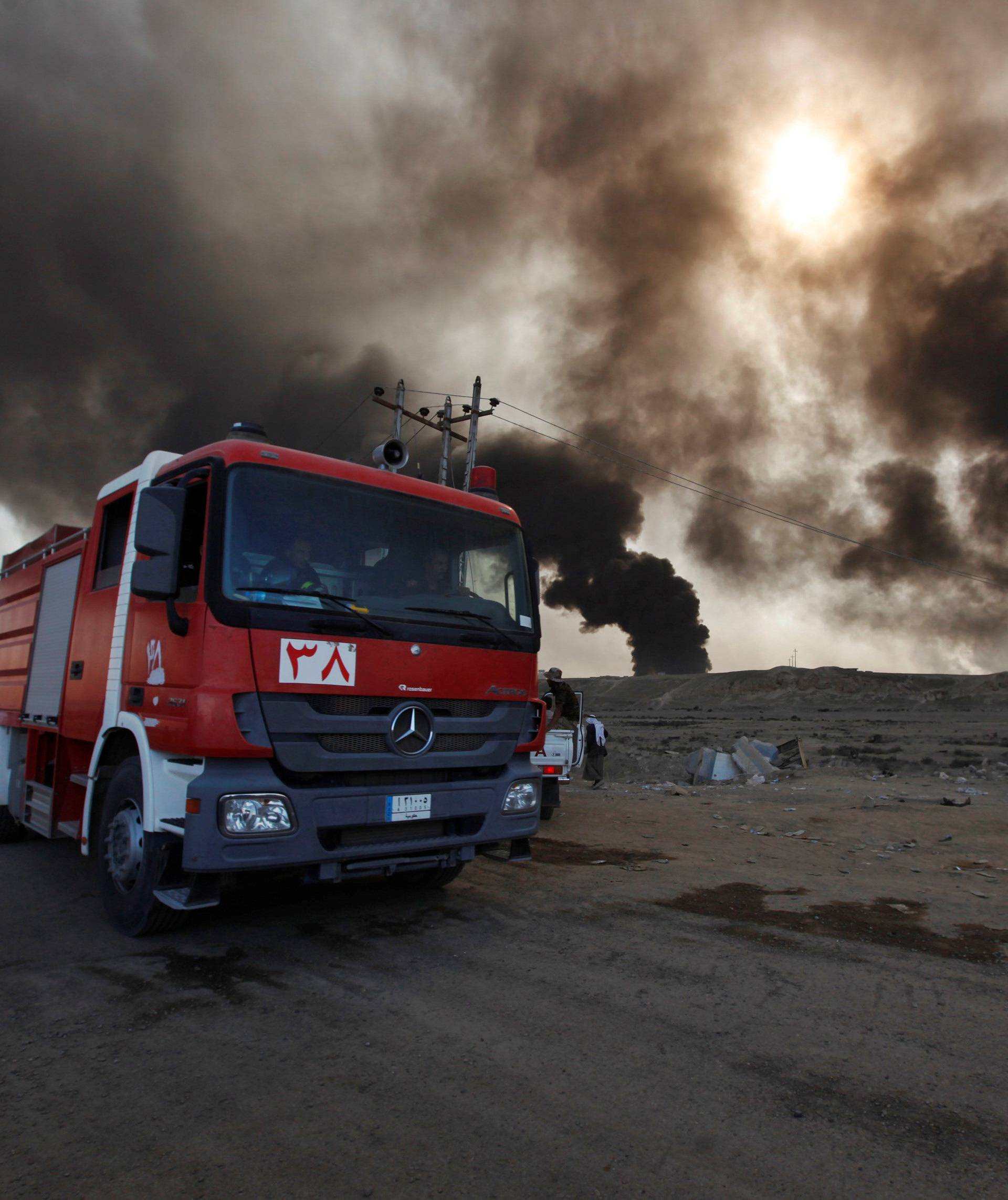 Fire trucks are seen in Qayyara