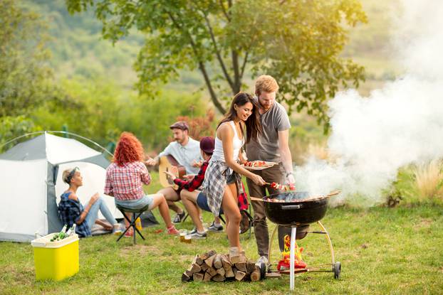 Young,Female,And,Male,Couple,Baking,Barbecue,In,Nature