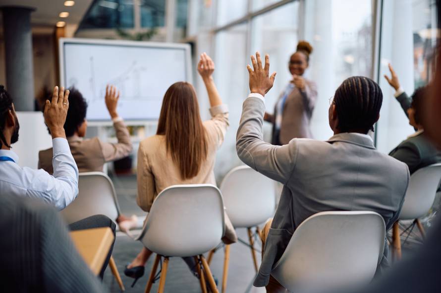 Rear,View,Of,A,Business,People,Raising,Their,Hands,Hand