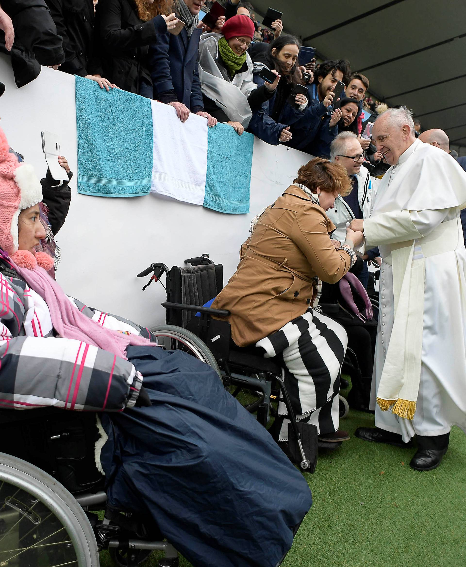Pope Francis greets a sick person as he arrives to lead a Holy Mass at the Swedbank Stadion in Malmo