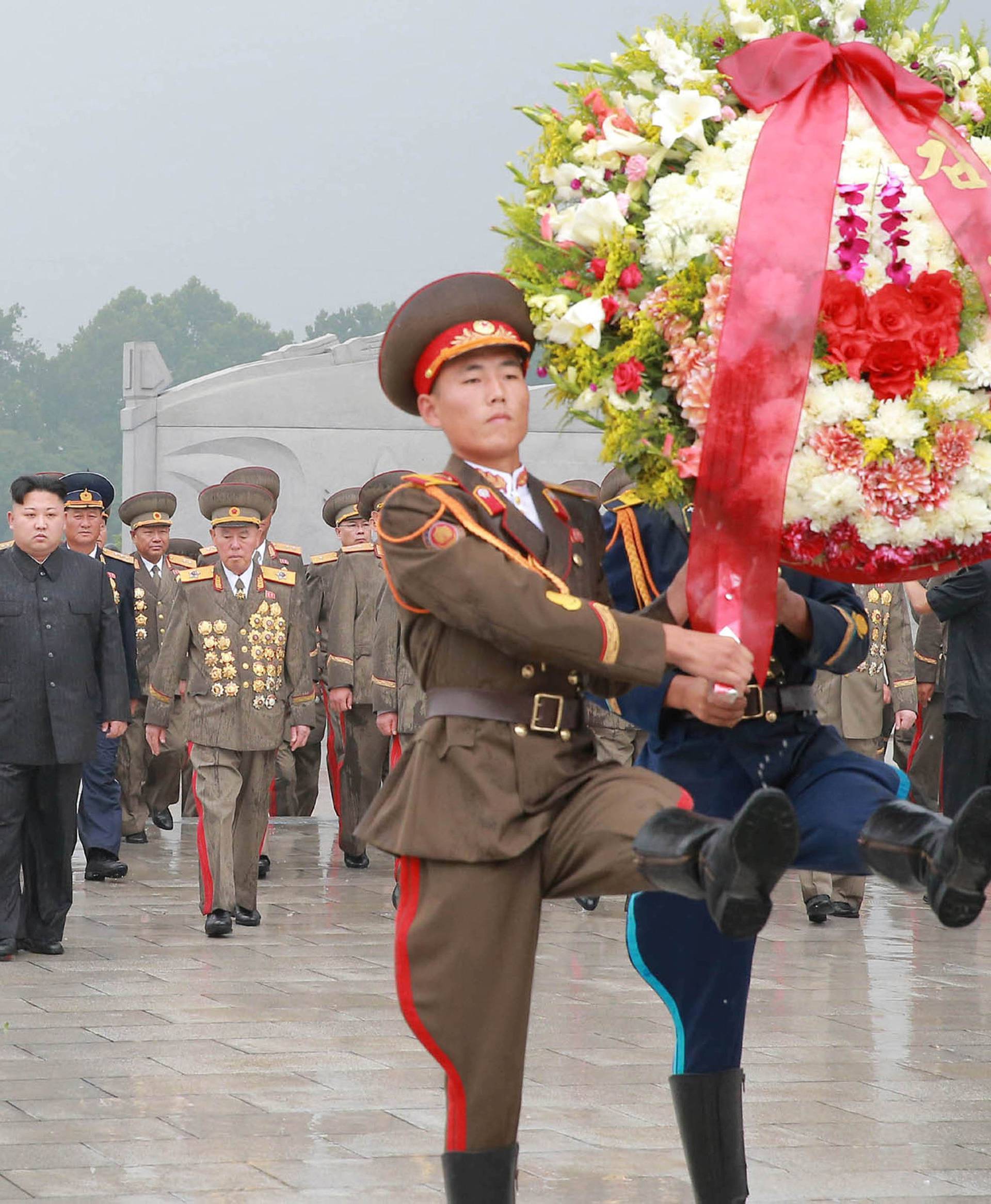 North Korean leader Kim Jong Un visits war graves to pay respects to war dead for the 64th anniversary of the armistice which ended the Korean War, in this undated photo released by KCNA