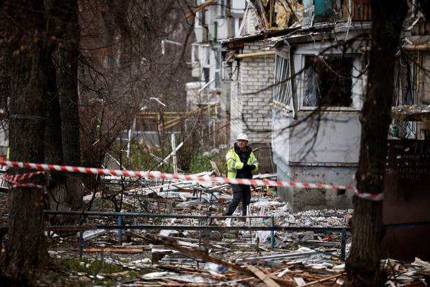 Emergency responders work at the site of a Russian drone strike on an apartment building, in Kyiv