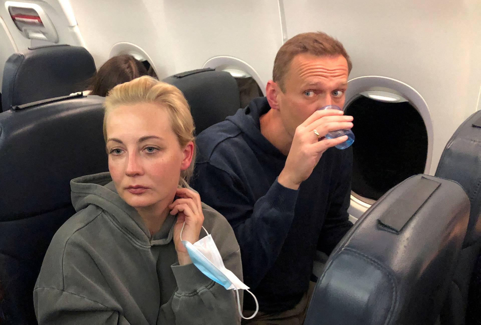 FILE PHOTO: Russian opposition leader Alexei Navalny and his wife Yulia Navalnaya are seen on board a plane during a flight from Berlin to Moscow