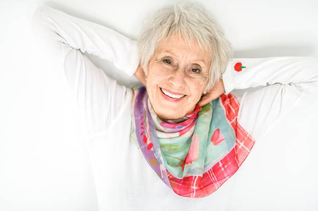 senior lady posing on white background look like relaxing