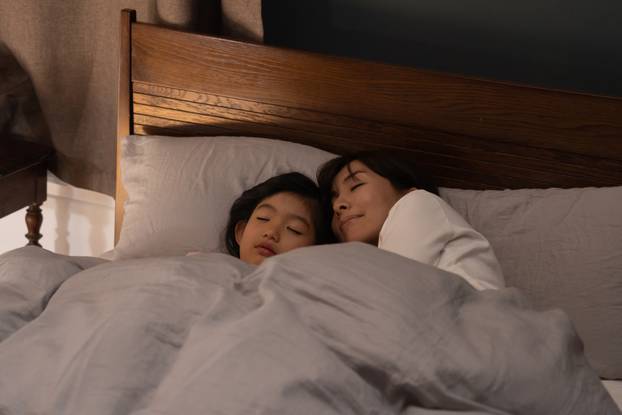 Asian,Parent,And,Child,Sleeping,In,Bed