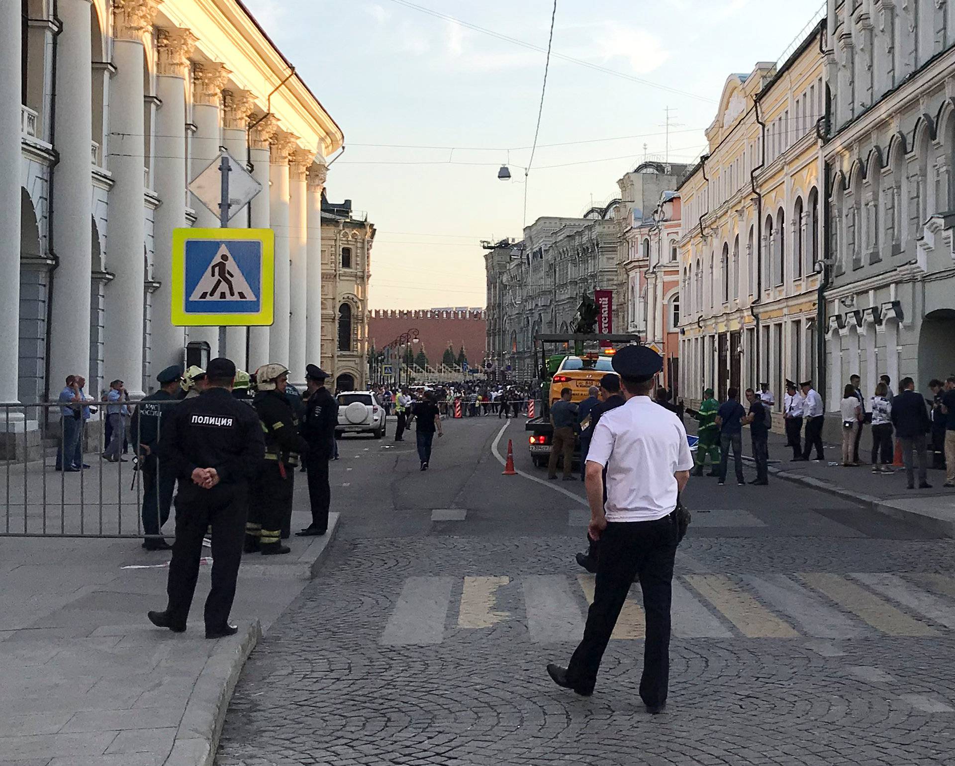 A damaged taxi, which ran into a crowd of people, is evacuated in central Moscow