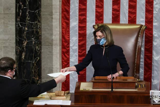 U.S. House Speaker Nancy Pelosi presides over the vote to impeach President Donald Trump