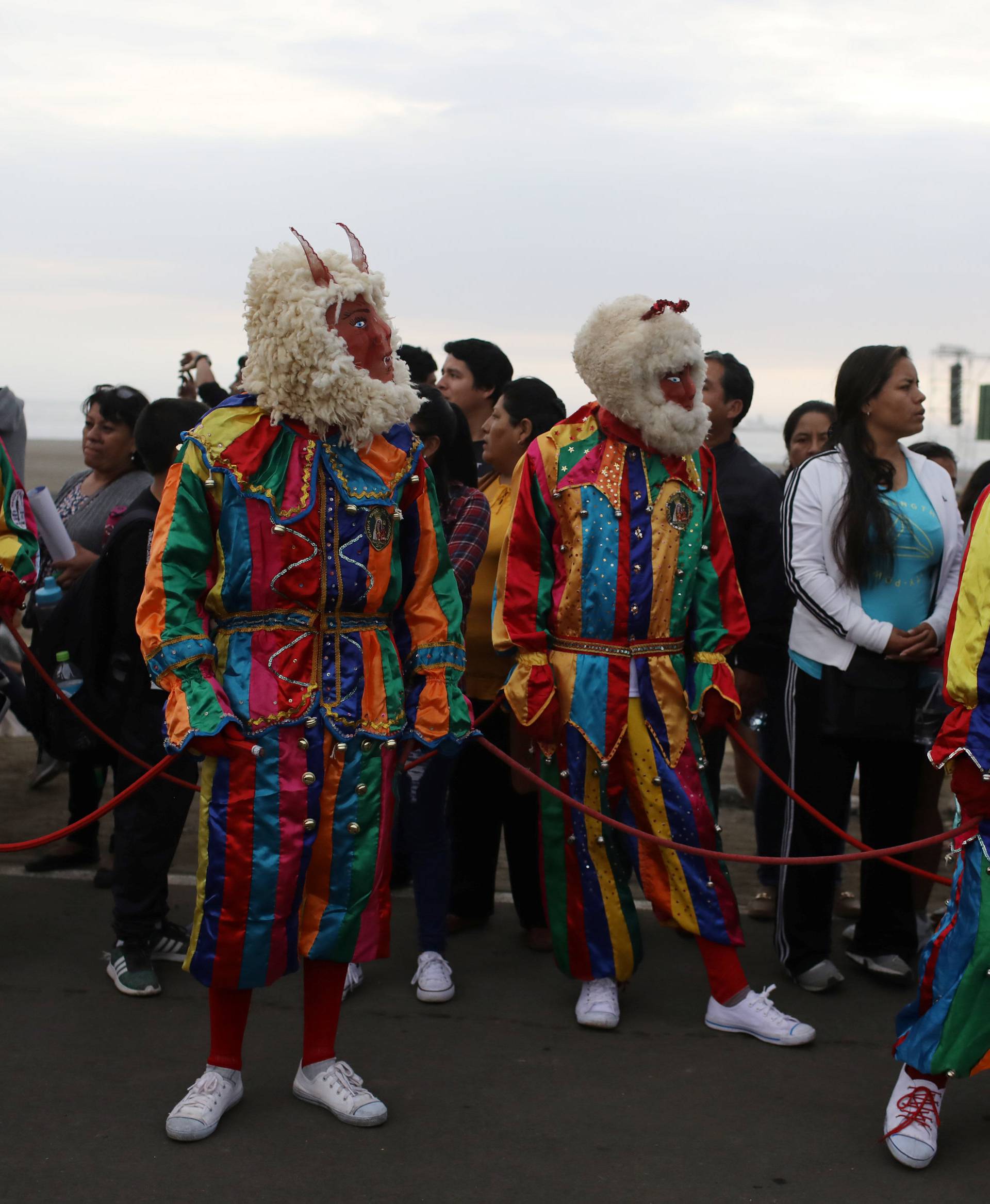 Faithfuls wearing "La Diablada" dance costumes take part in a procession to the Huanchaco beach, where Pope Francis will hold a mass, in Trujillo, Peru