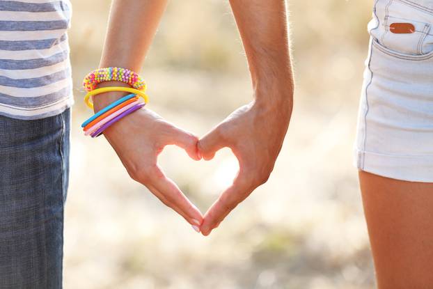 Happy couple holding hands, outdoors