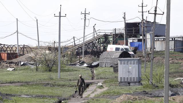 A miner walks at a coal mine following a methane explosion near Luhansk