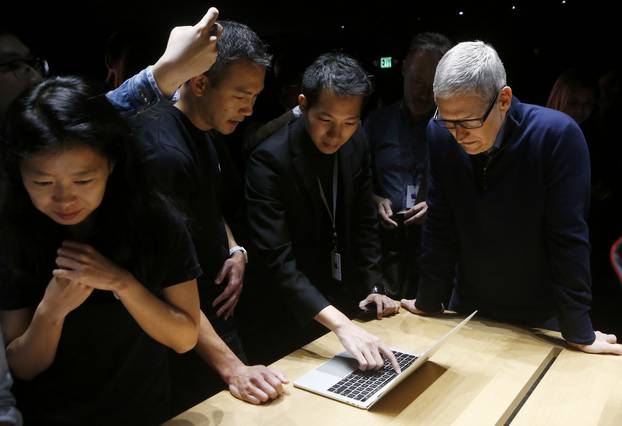 Apple CEO Tim Cook views the new MacBook Pro in the demo room after an Apple media event in Cupertino