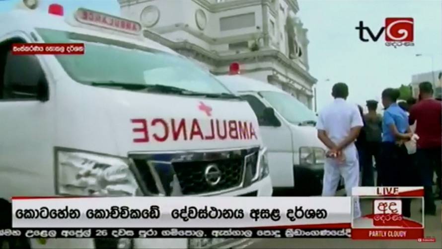 Ambulances wait outside St Anthony's church after explosions hit churches and hotels in Colombo