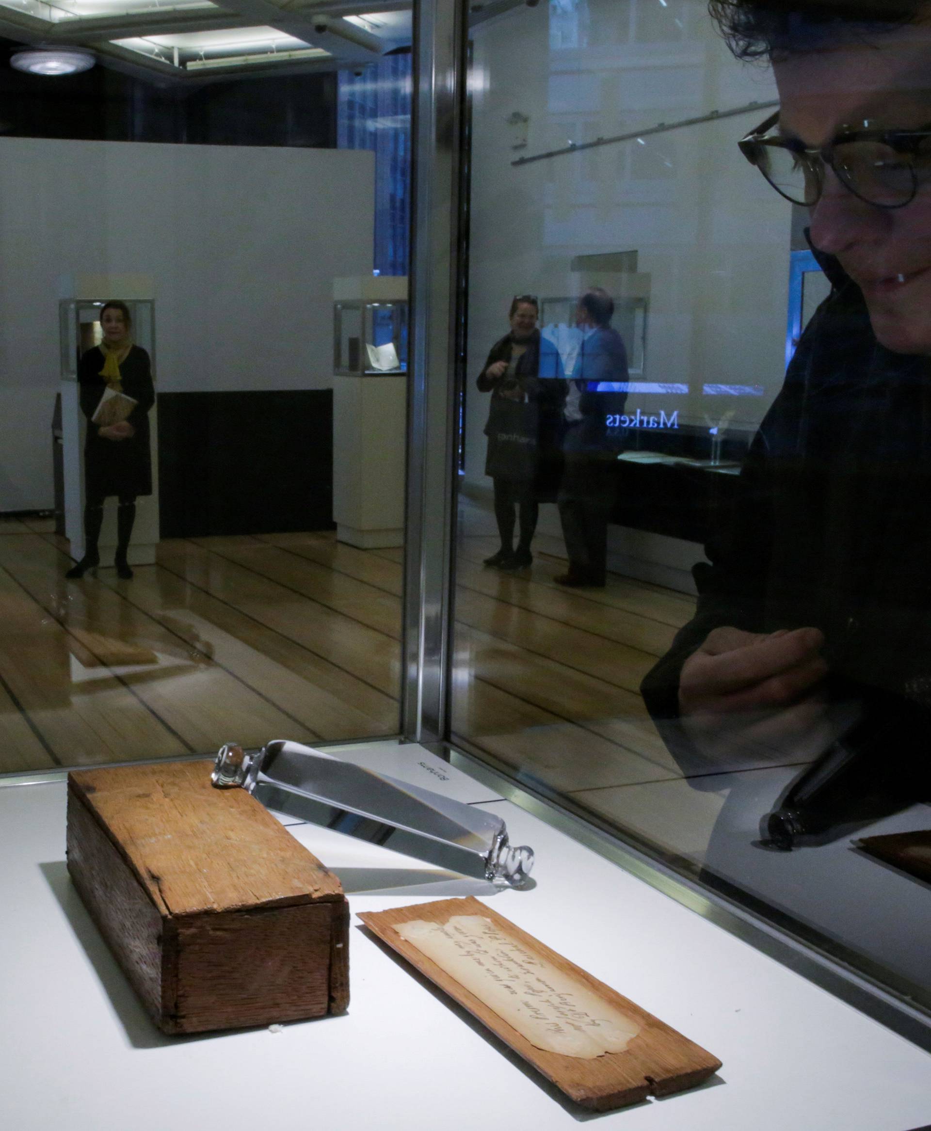 A man looks at a prism belonging to Benjamin Franklin which is displayed at Bonhams auction house in New York