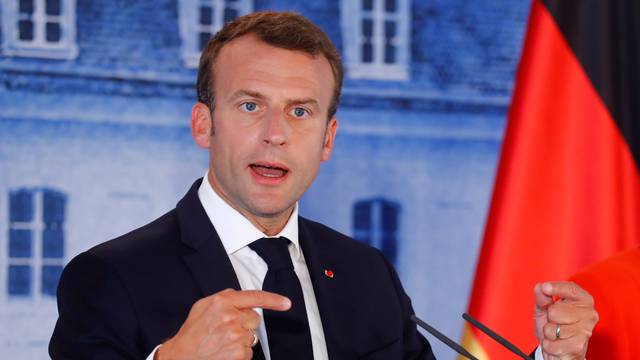 German Chancellor Angela Merkel and French President Emmanuel Macron attend a press conference after their meeting at the German government guesthouse Meseberg Palace in Meseberg