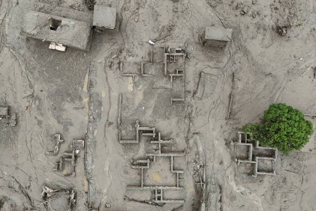 A drone view shows mud covering buildings following a flash flood in Trishuli