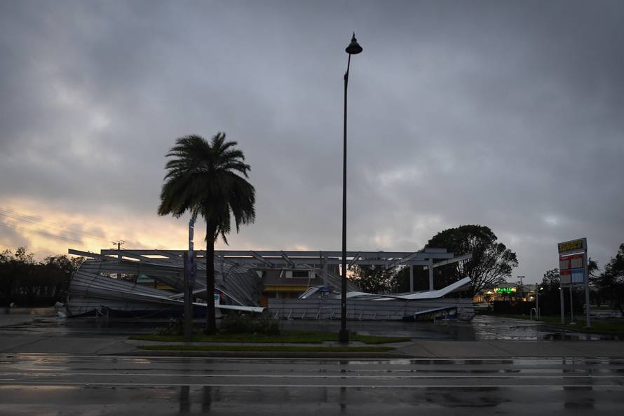 The crumbled canopy of a gas station damaged by hurricane Irma in Bonita Springs