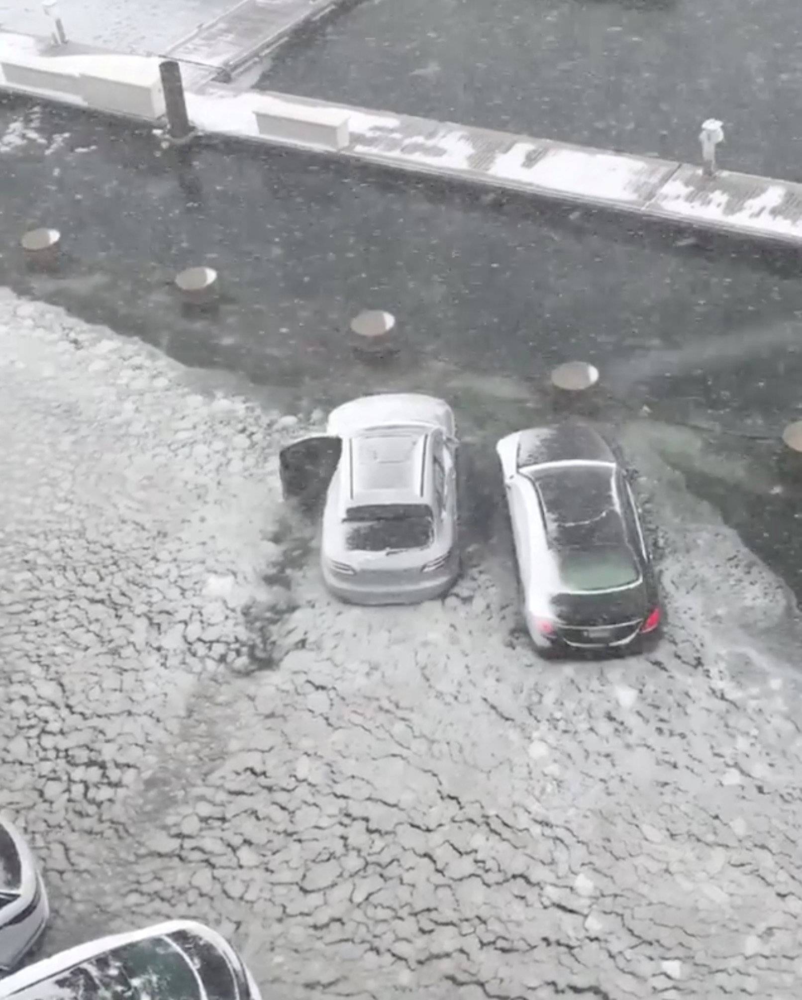 Cars are seen on a flooded street in Boston