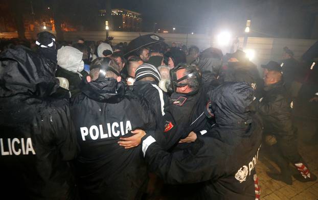 Supporters of the opposition party clash with the police during an anti-government protest in front of the Parliament Building in Tirana