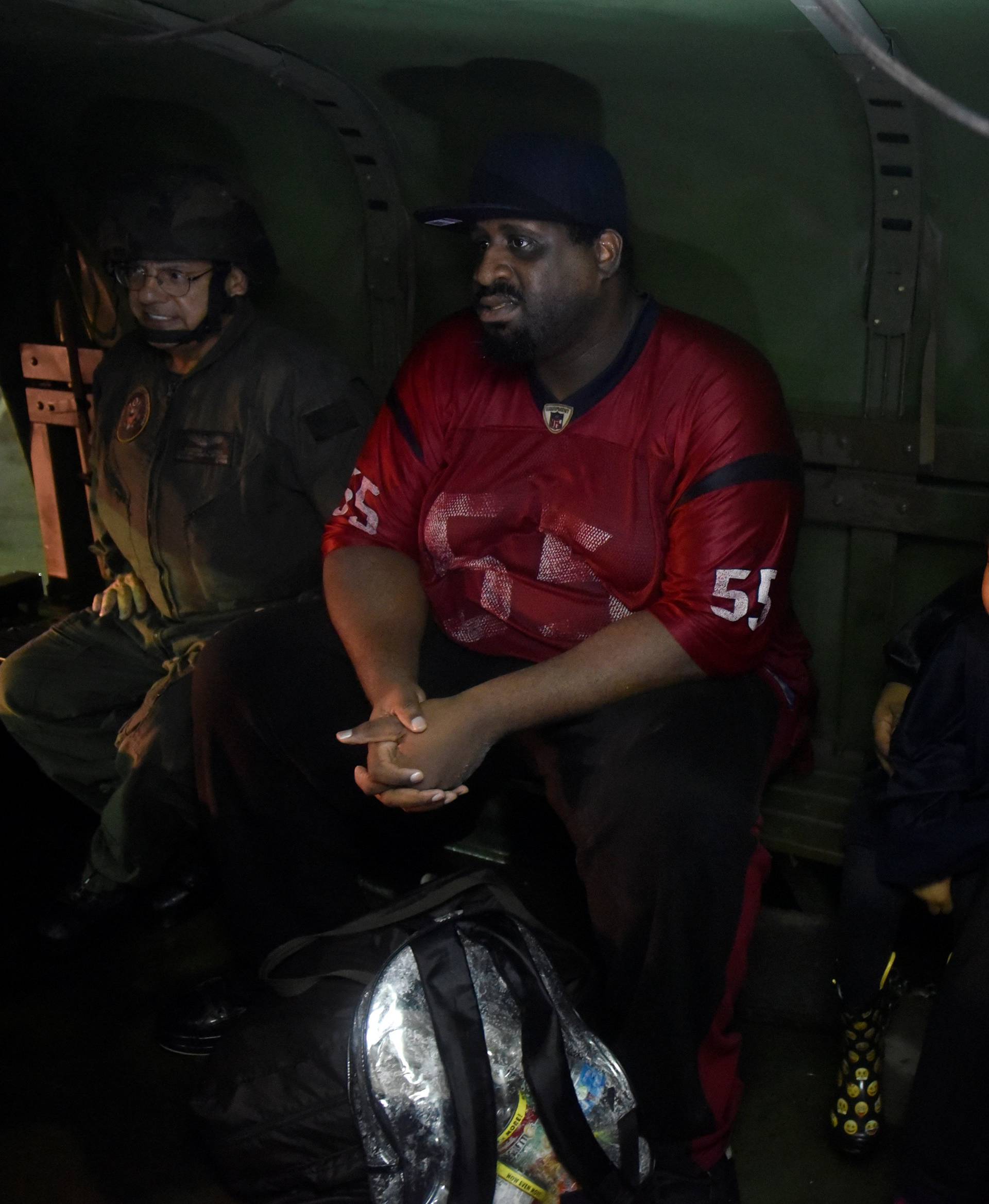 Volunteer Ray Marino (L), and evacuees Charles Hayes, Paisleigh Mitchell, 3, and Taylor Mitchell, ride in the back of a civilian owned military vehicle after Hurricane Harvey inundated the Texas Gulf coast with rain causing widespread flooding, in Houston