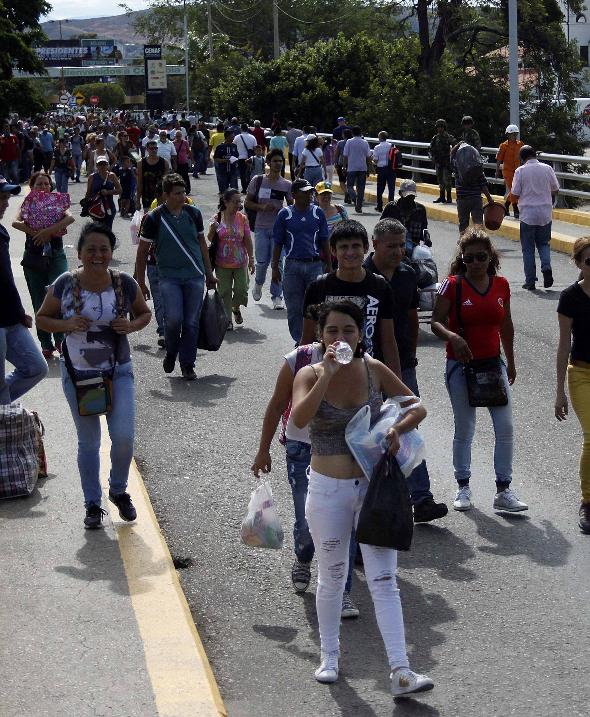 People cross to Venezuela over the Simon Bolivar international bridge after shopping in Cucuta