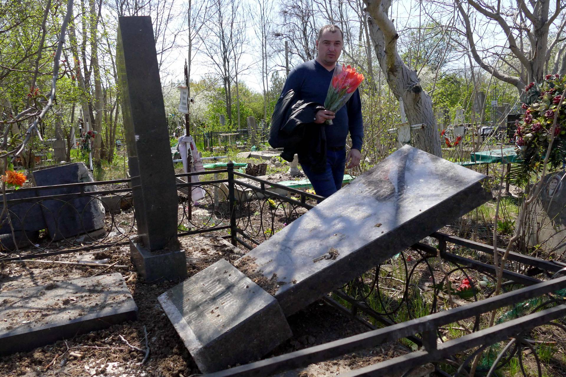 People visit Tairovske cemetery during memorial weekend