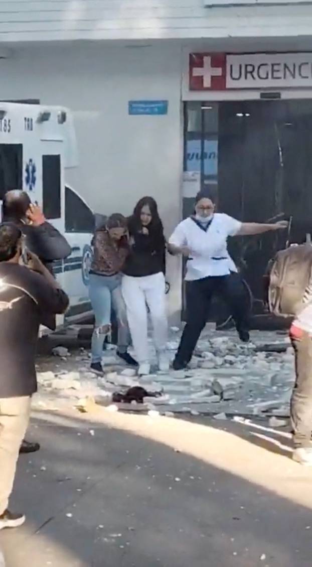 People run out of the hospital building during an earthquake in Cali
