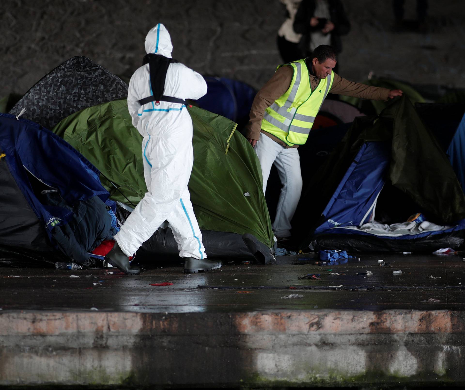A makeshift camp is cleared away after French police evacuated hundreds of migrants living in tents along a canal in Paris