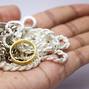 silver and gold ornaments held in the hand. Latest design silver chains and gold ring held in hand