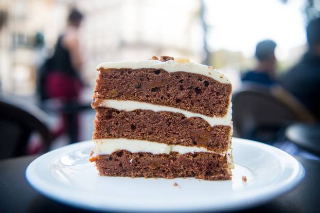 Cake slice on white plate in paris, france, dessert. Cake with cream, food. Temptation, appetite concept. Dessert, food, snack, pastry. Cuisine, menu, dish, recipe