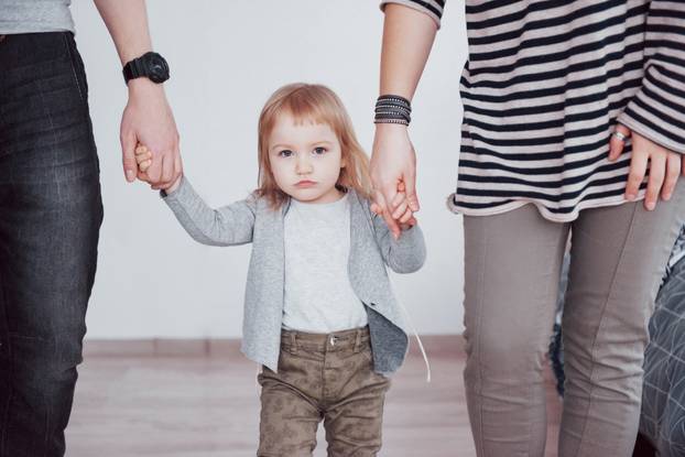 happy family is having fun at home. Mother, father and little daughter with plush toy are enjoying being together