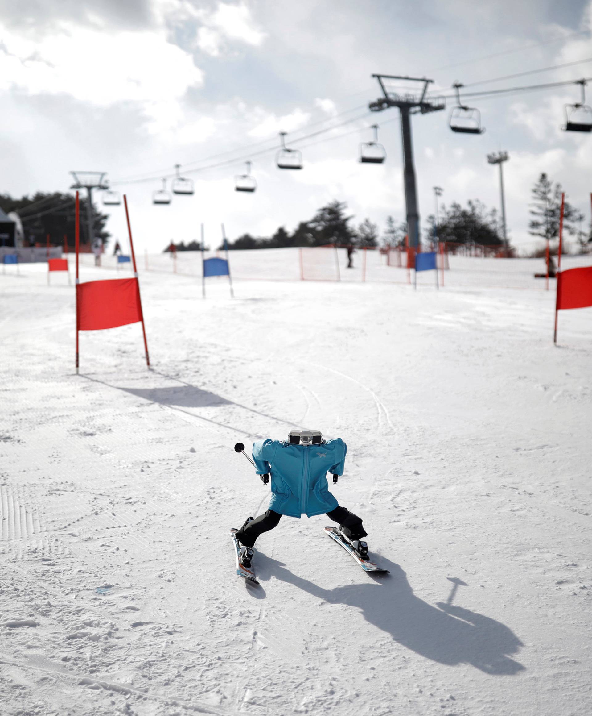 Robot Tae Kwon V skies during the Ski Robot Challenge at a ski resort in Hoenseong