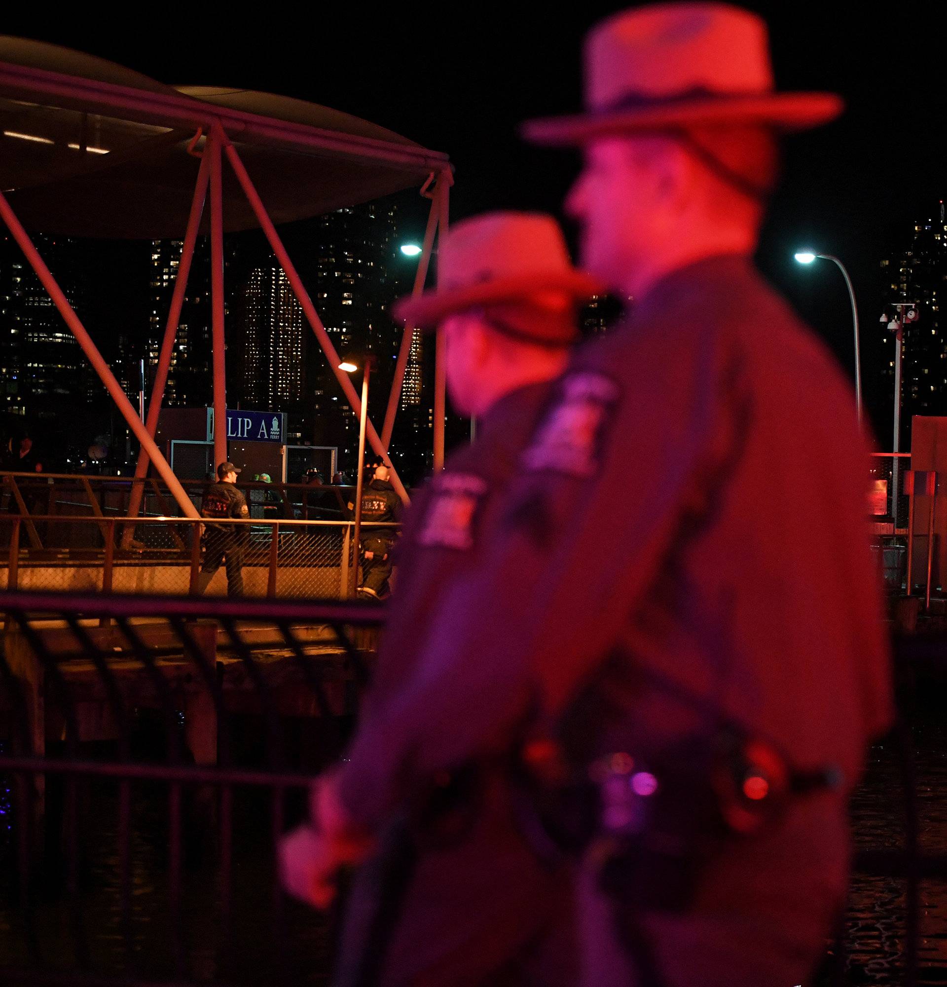 New York State Police are seen near East 34th Street/Midtown East Landing after a chartered Liberty Helicopters helicopter crashed into the East River in New York