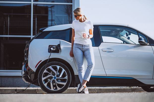 Woman,Charging,Electro,Car,At,The,Electric,Gas,Station