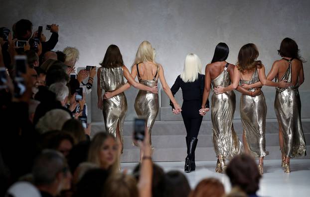 Italian designer Donatella Versace acknowledges the applause with former top models Carla Bruni, Claudia Schiffer, Naomi Campbell, Cindy Crawford and Helena Christensen at the end of Versace Spring/Summer 2018 show at the Milan Fashion Week in Milan