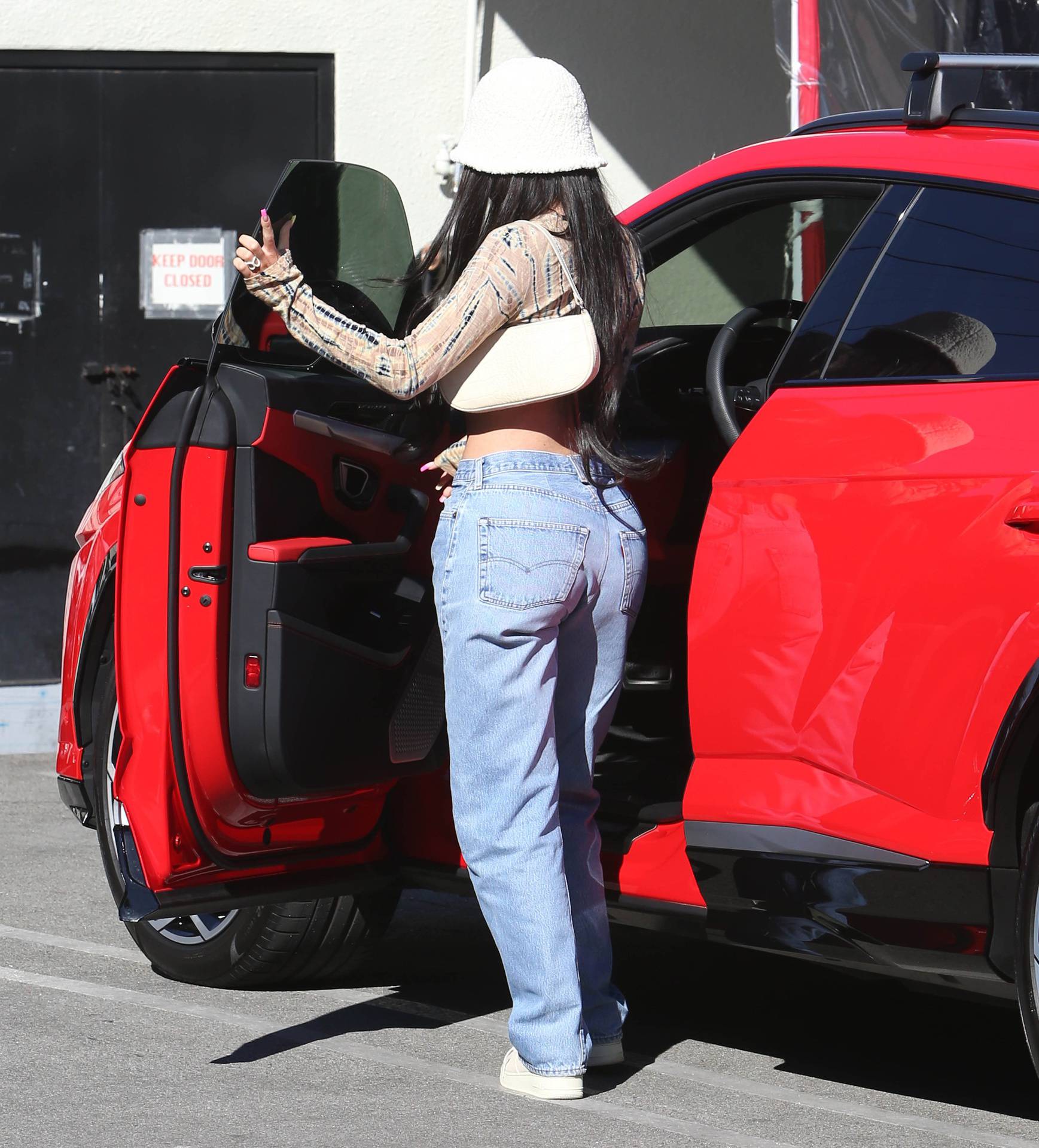 EXCLUSIVE: Kylie Jenner turns heads in a crop-top and denim jeans as she hits up 'Matsuhisa' Sushi Restaurant with BFF Stassie in Beverly Hills, CA