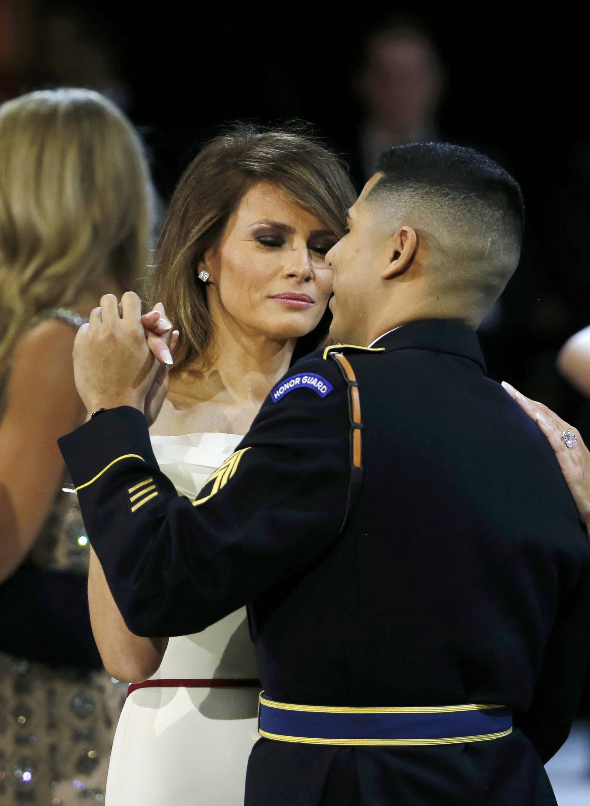 U.S. Navy Petty Officer Second Class Catherine Cartmell dances with President Trump as United States Army Staff Sergeant Jose A. Medina dances with First Lady Melania Trump during the Salute to Our Armed Services Ball in Washington