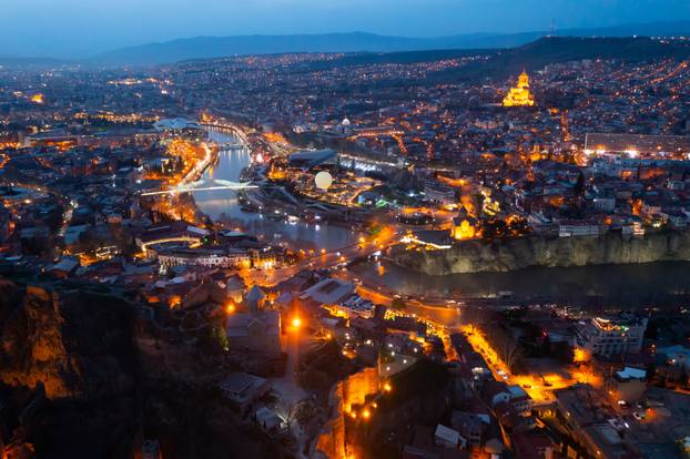 Night aerial view of Tbilisi city with Kura river