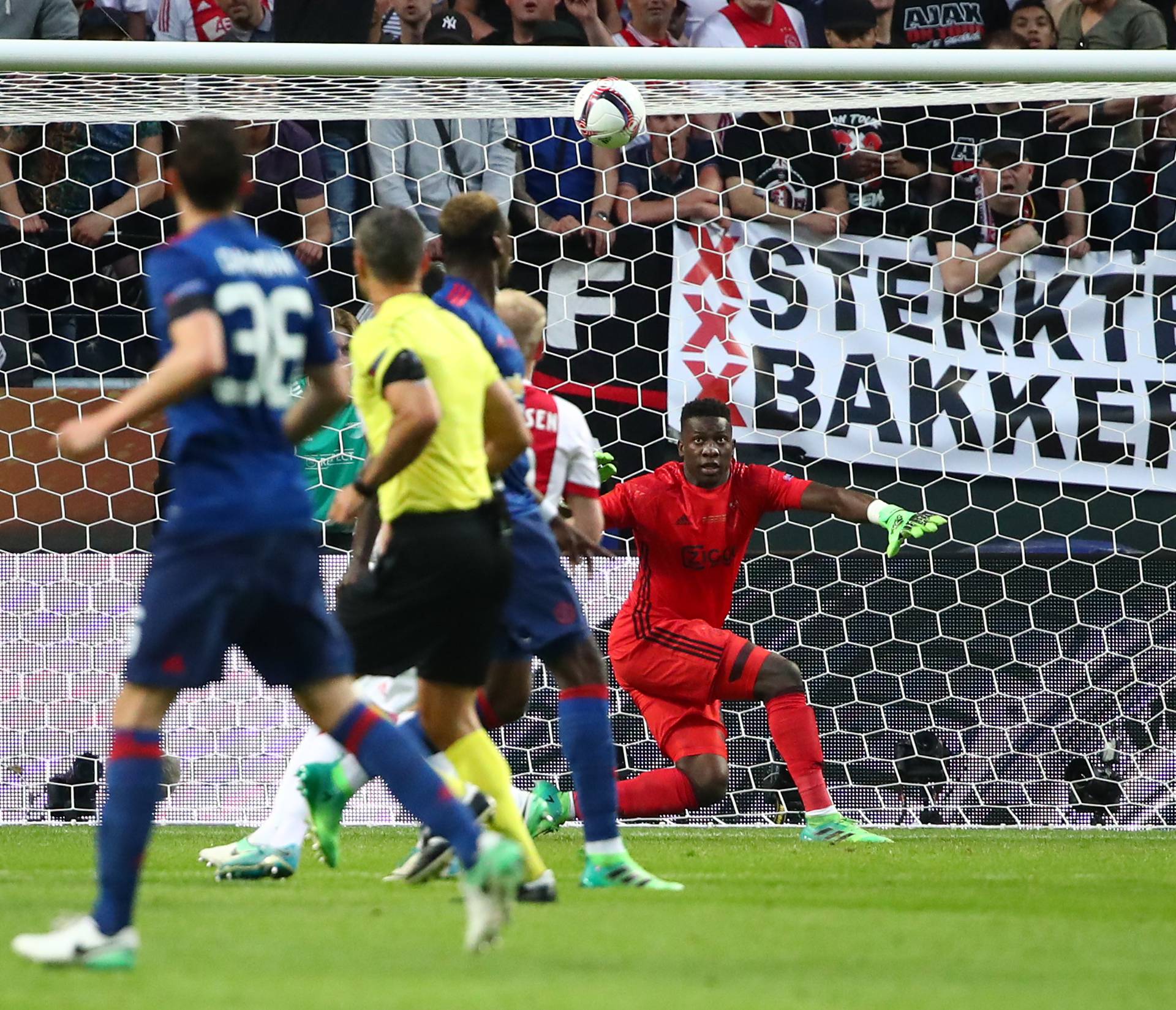 Manchester United's Paul Pogba scores their first goal past Ajax's Andre Onana