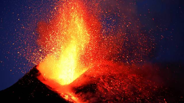 FILE PHOTO: Italy's Mount Etna, Europe's tallest and most active volcano, spews lava as it erupts on the southern island of Sicily