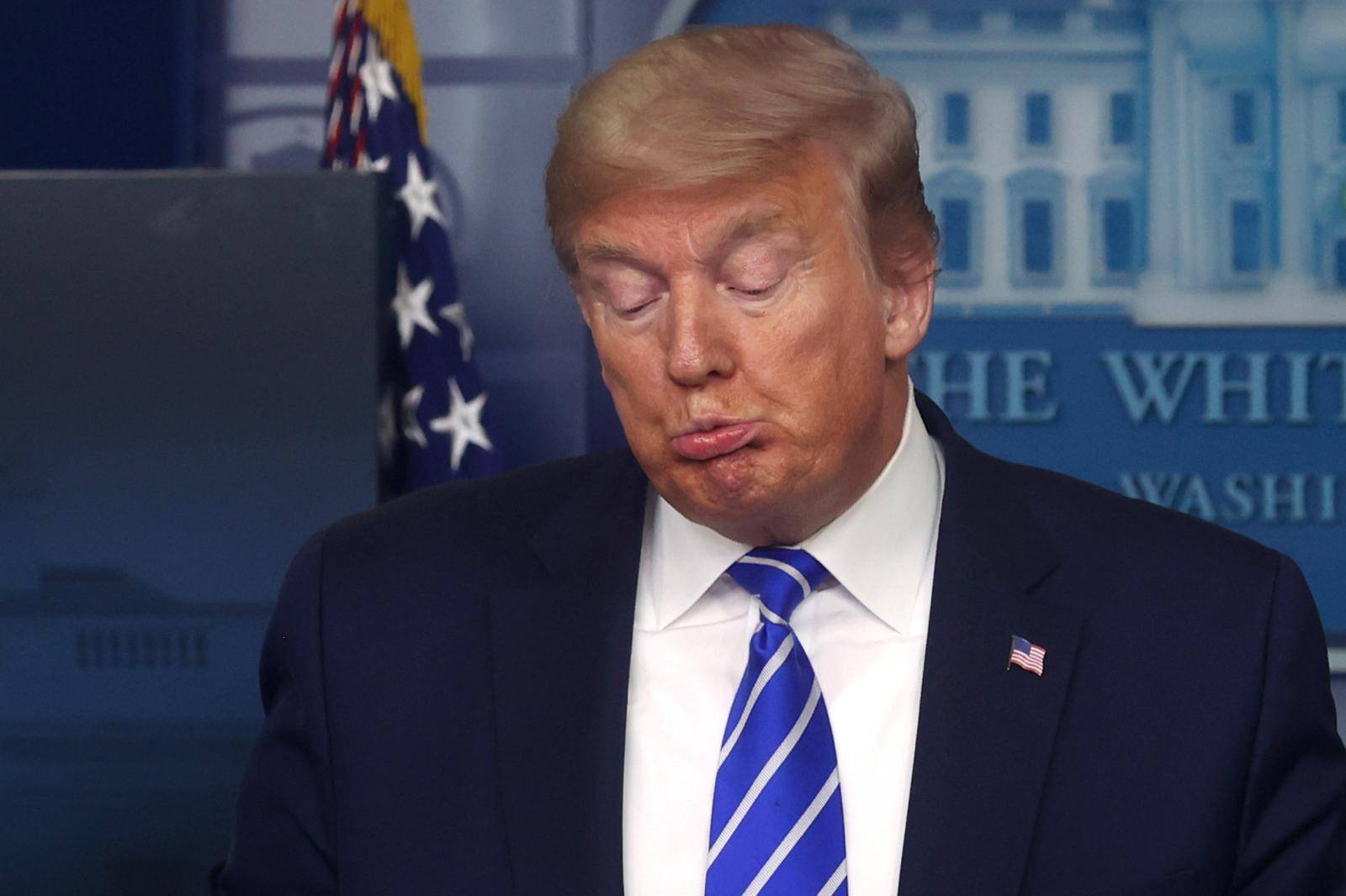 U.S. President Donald Trump reacts as he leads the daily coronavirus disease outbreak task force briefing at the White House in Washington