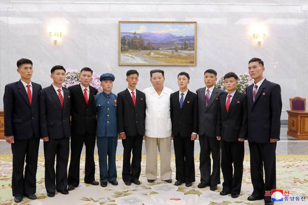 North Korean leader Kim Jong Un poses as he meets young people, in Pyongyang