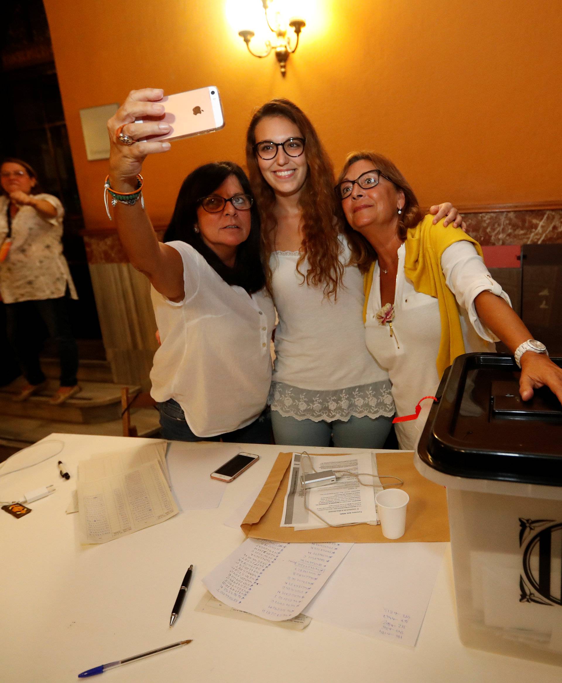  Polling station staff take a selfie as voting ended for the banned independence referendum in Barcelona