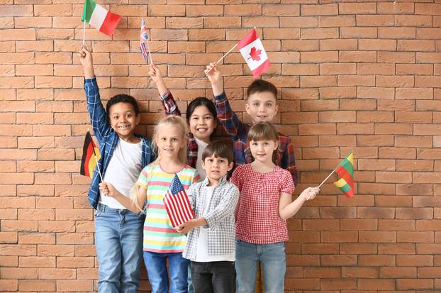Little,Pupils,Of,Language,School,On,Brick,Background