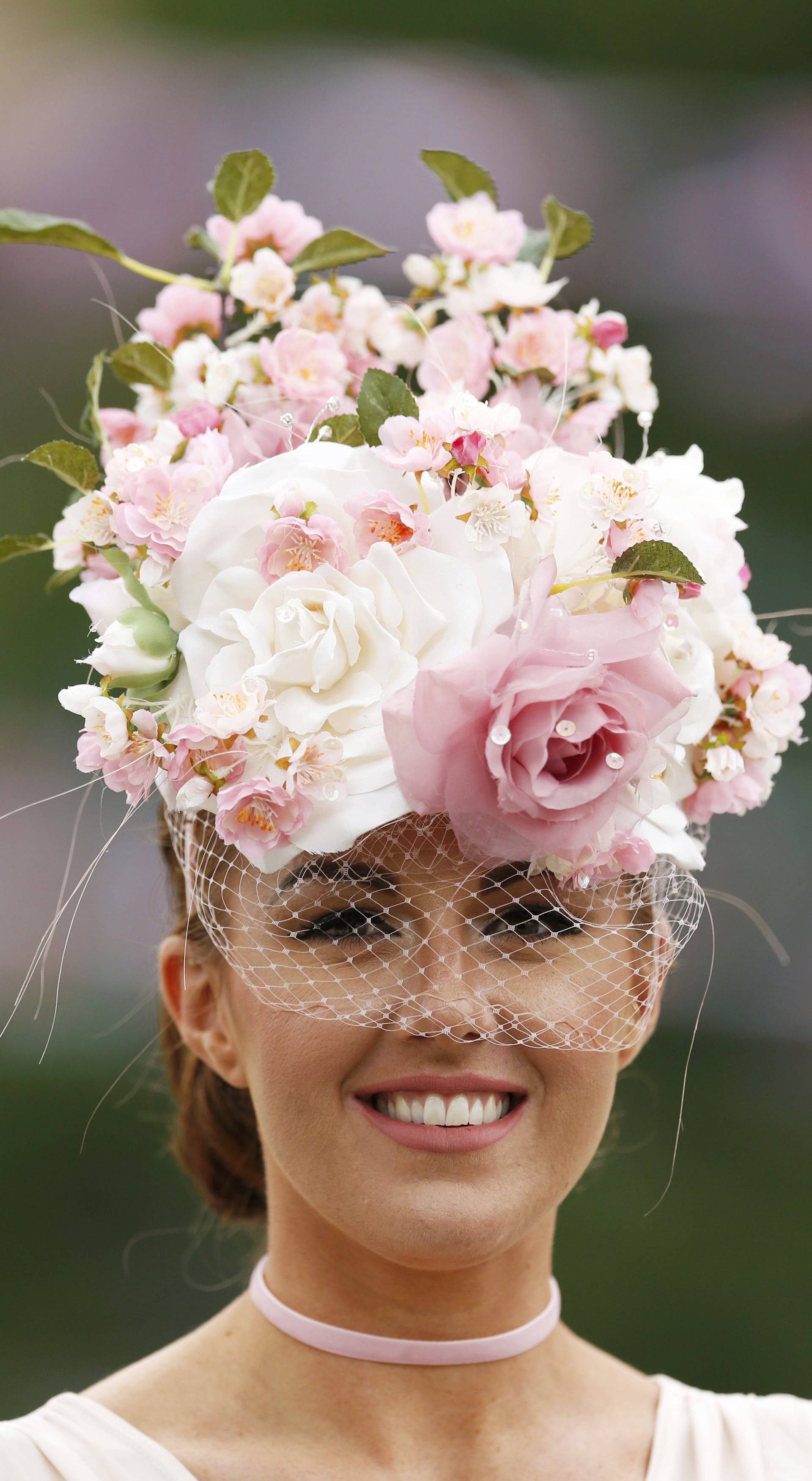 Britain Horse Racing Ladies Day Racegoer wears hat