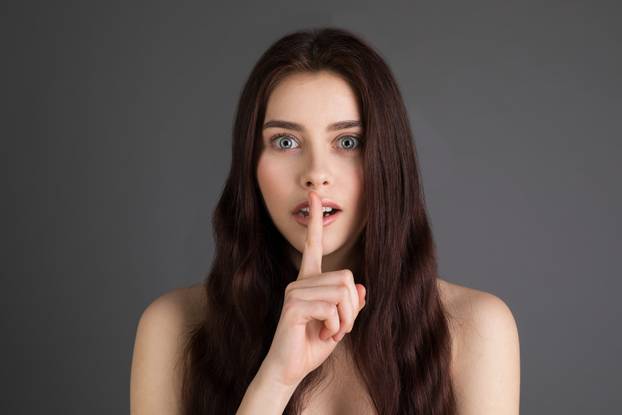 Beautiful brunette girl with bare shoulders, blue eyes